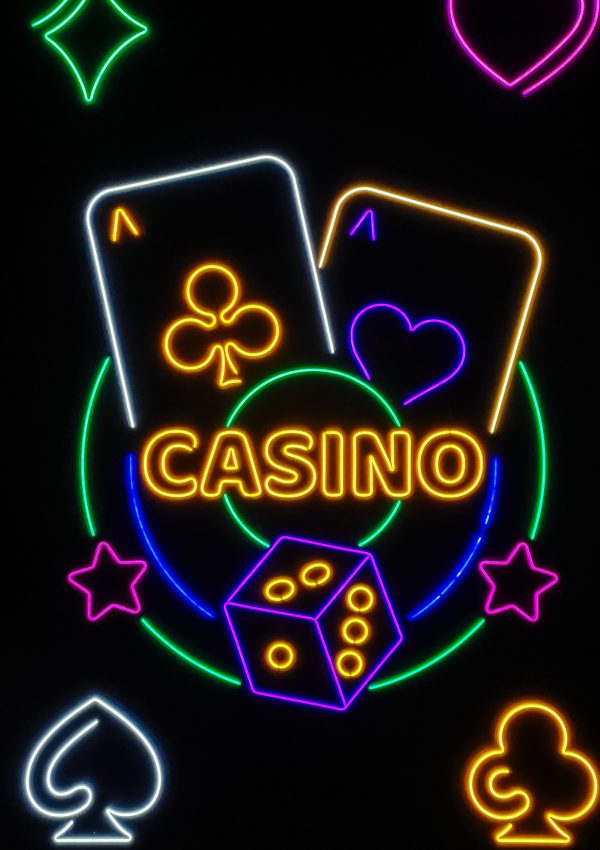 Casino neon sign with glowing dice and cards